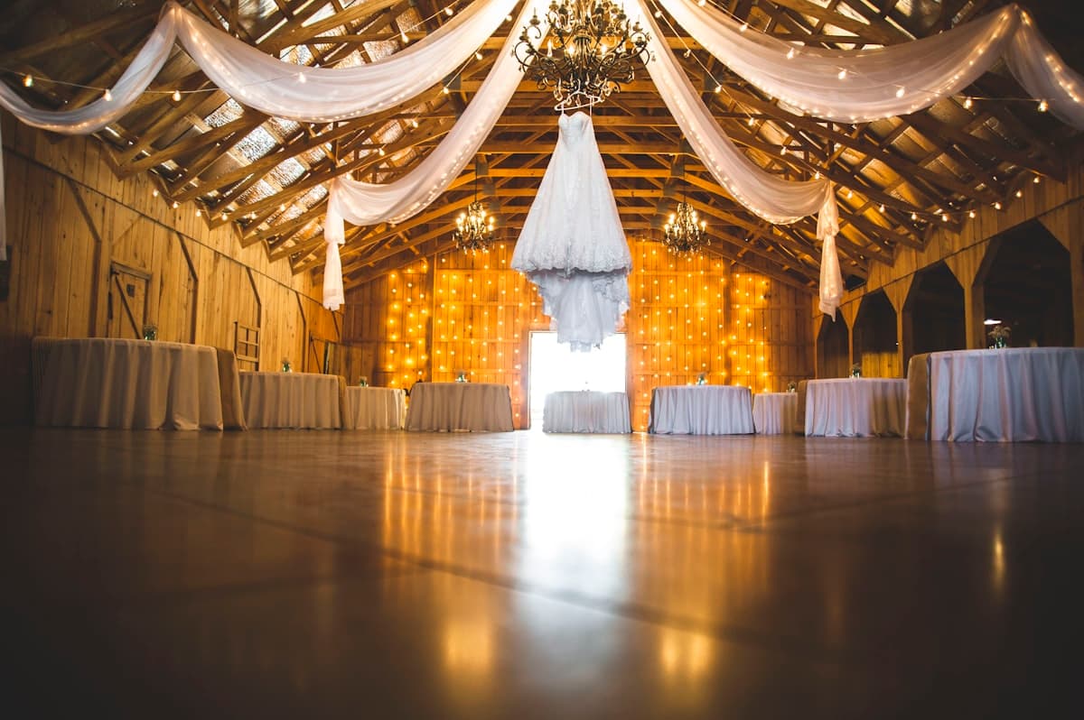 Warm barn venue with draped fabric and golden light